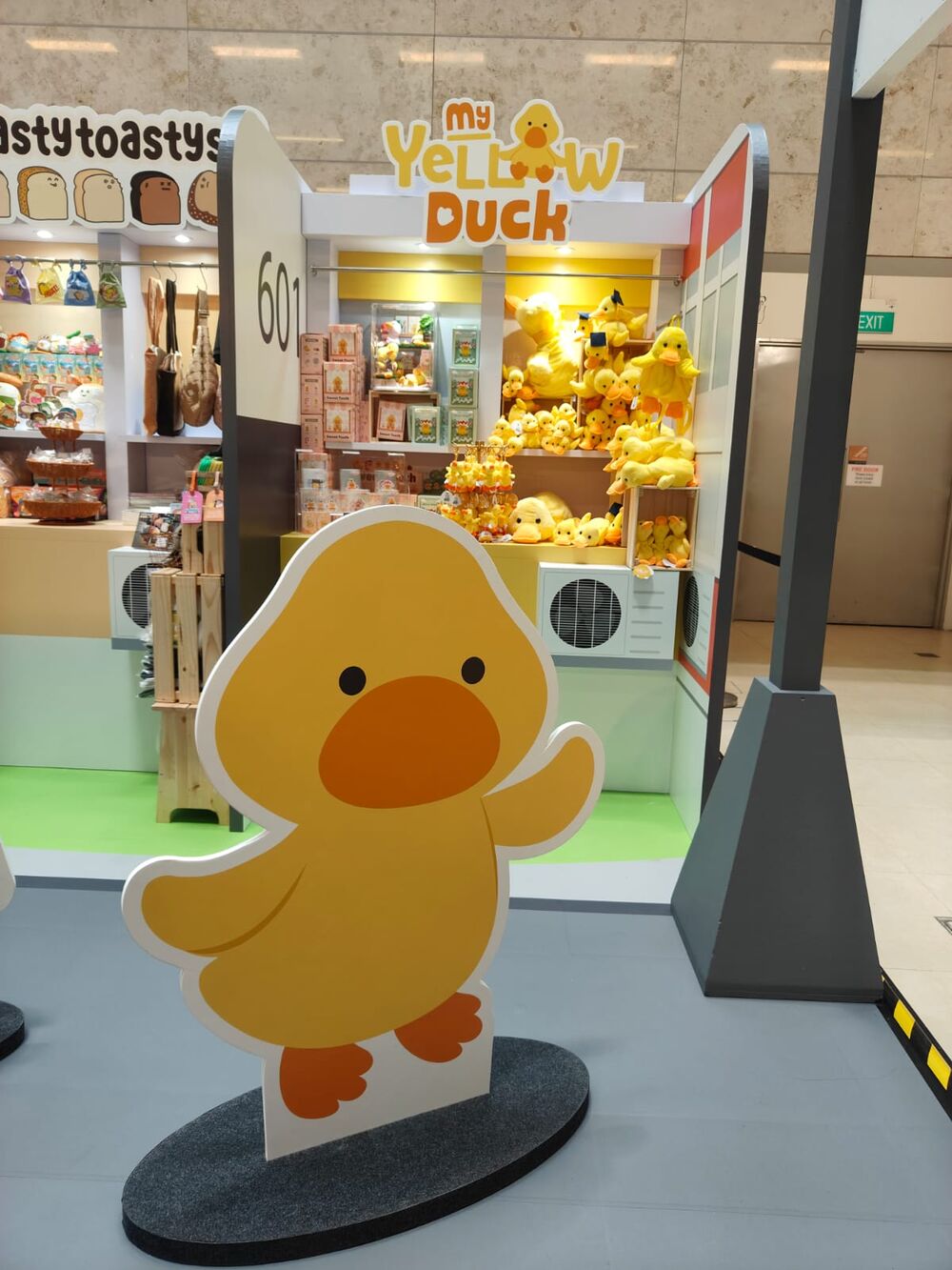 Life-size My Yellow Duck cutout standee outside a store