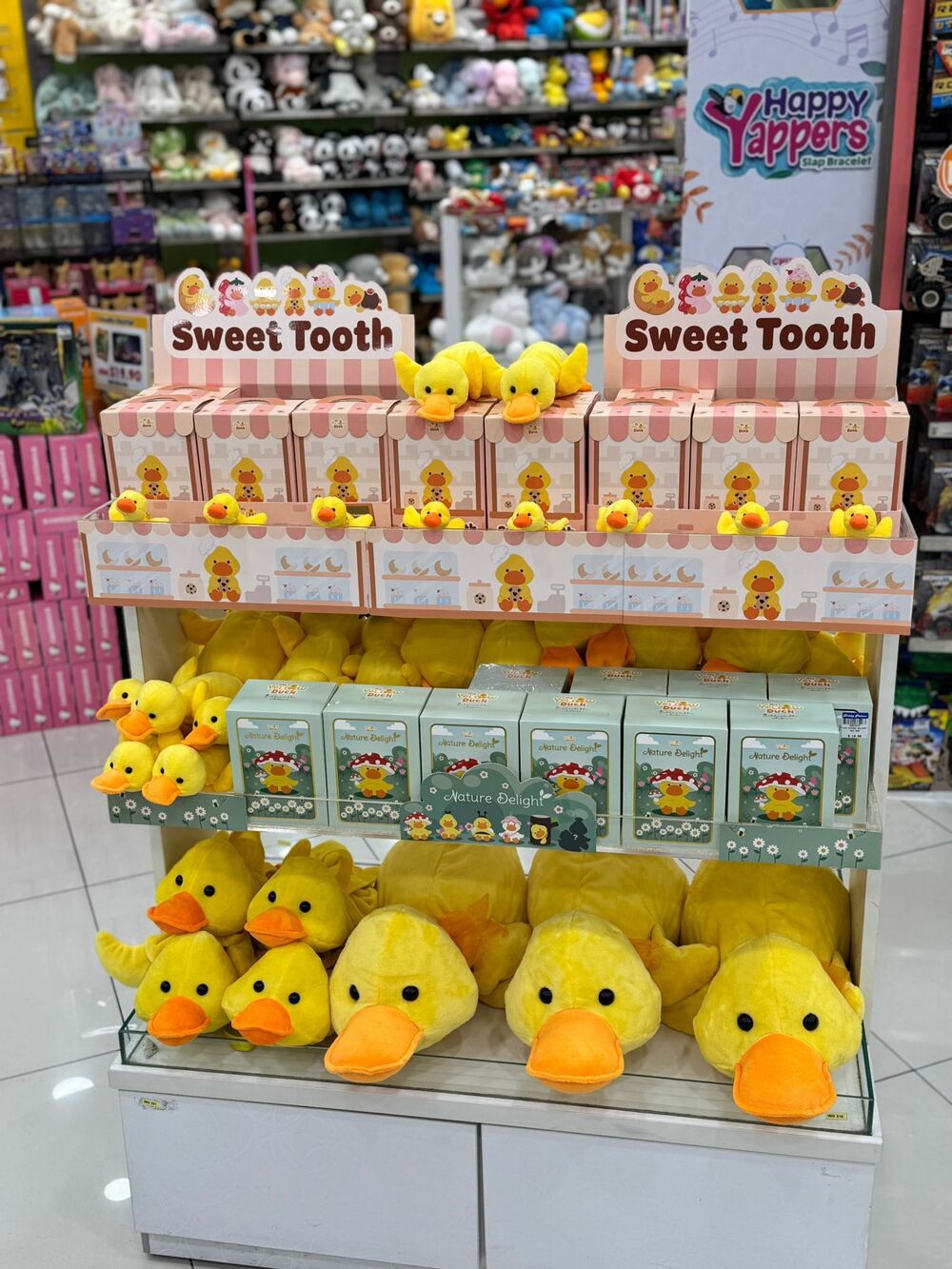 Sweet Tooth boxes and plush ducks on shelf display